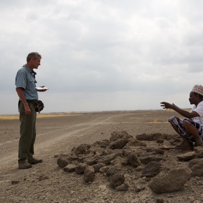 Paul Salopek interviewing Ahmed Elema, friend and guide on his walk from Herto to the Ethiopian-Djibouti border, as he visits the gravesite of Kondali Aki, his 8th generation grandfather who died sometime in the 19th century. This was a form of respect and prayer before beginning the journey with Paul later in the day. Afar region, Ethiopia.
